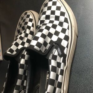 Silver and black checkered slip on vans